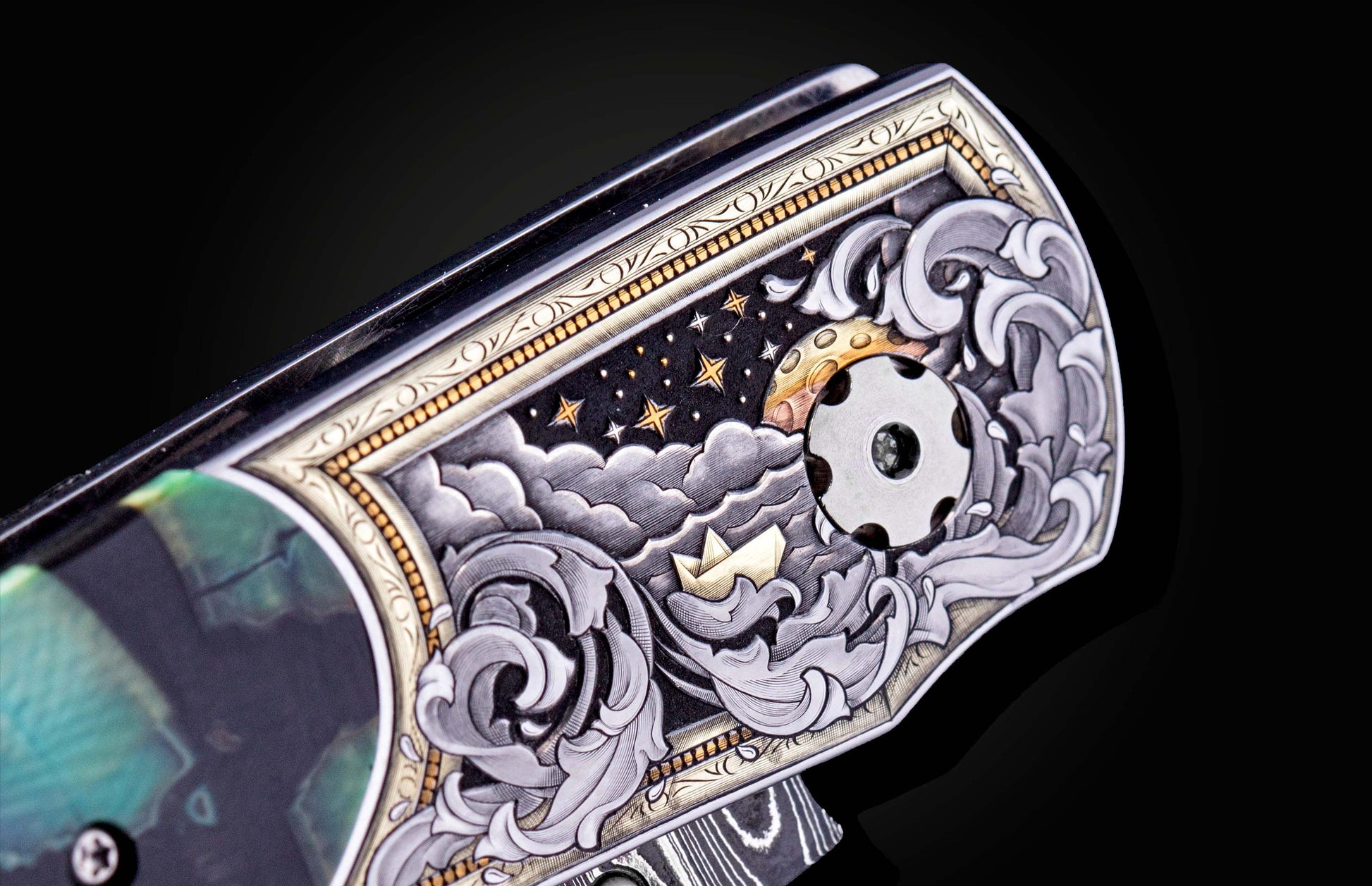 Decorative knife blade with intricate designs on a black background