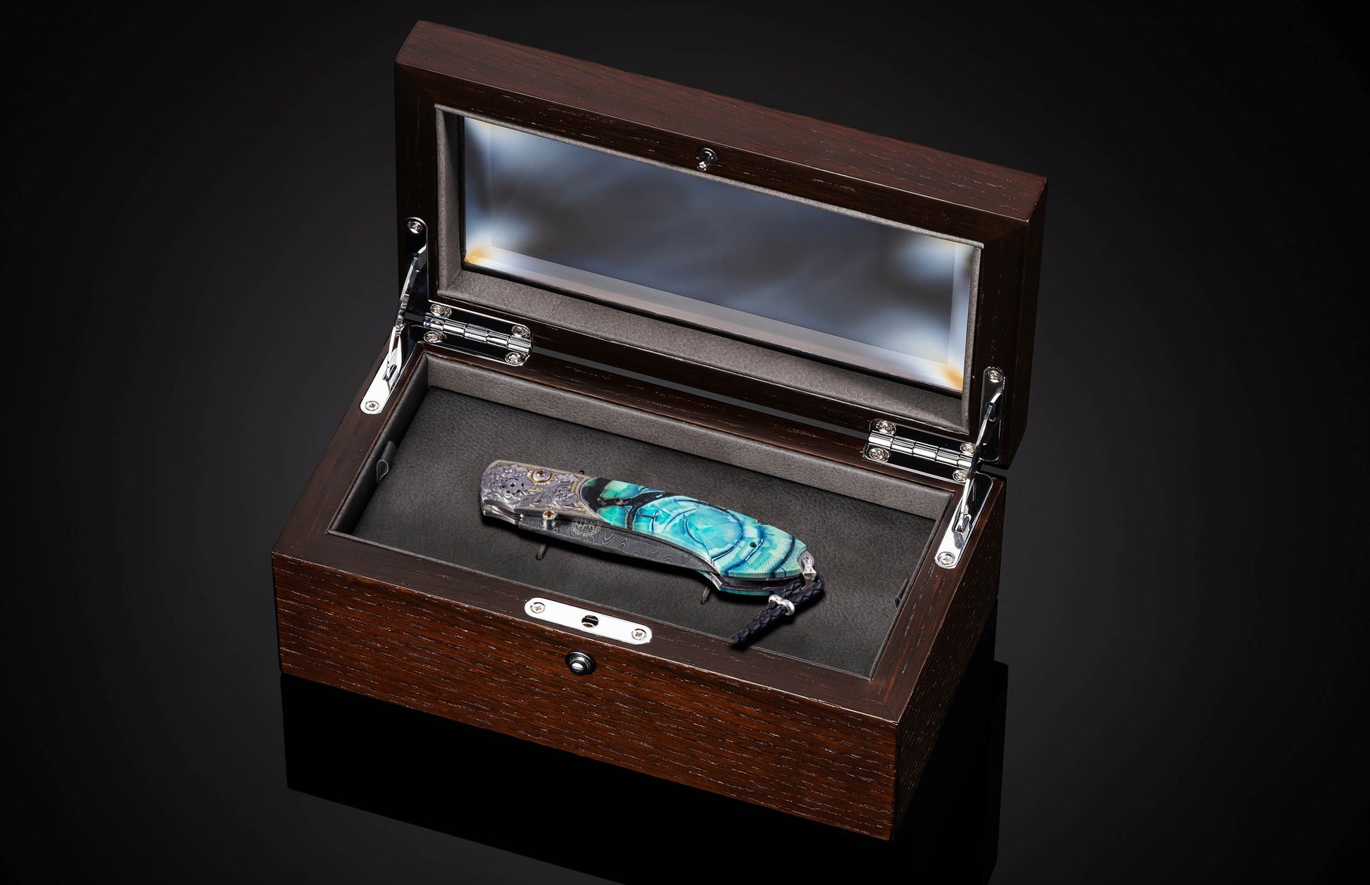 Decorative knife in a wooden box on a dark background
