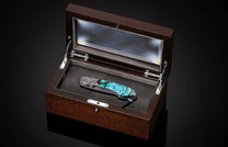 Decorative knife in a wooden box on a dark background