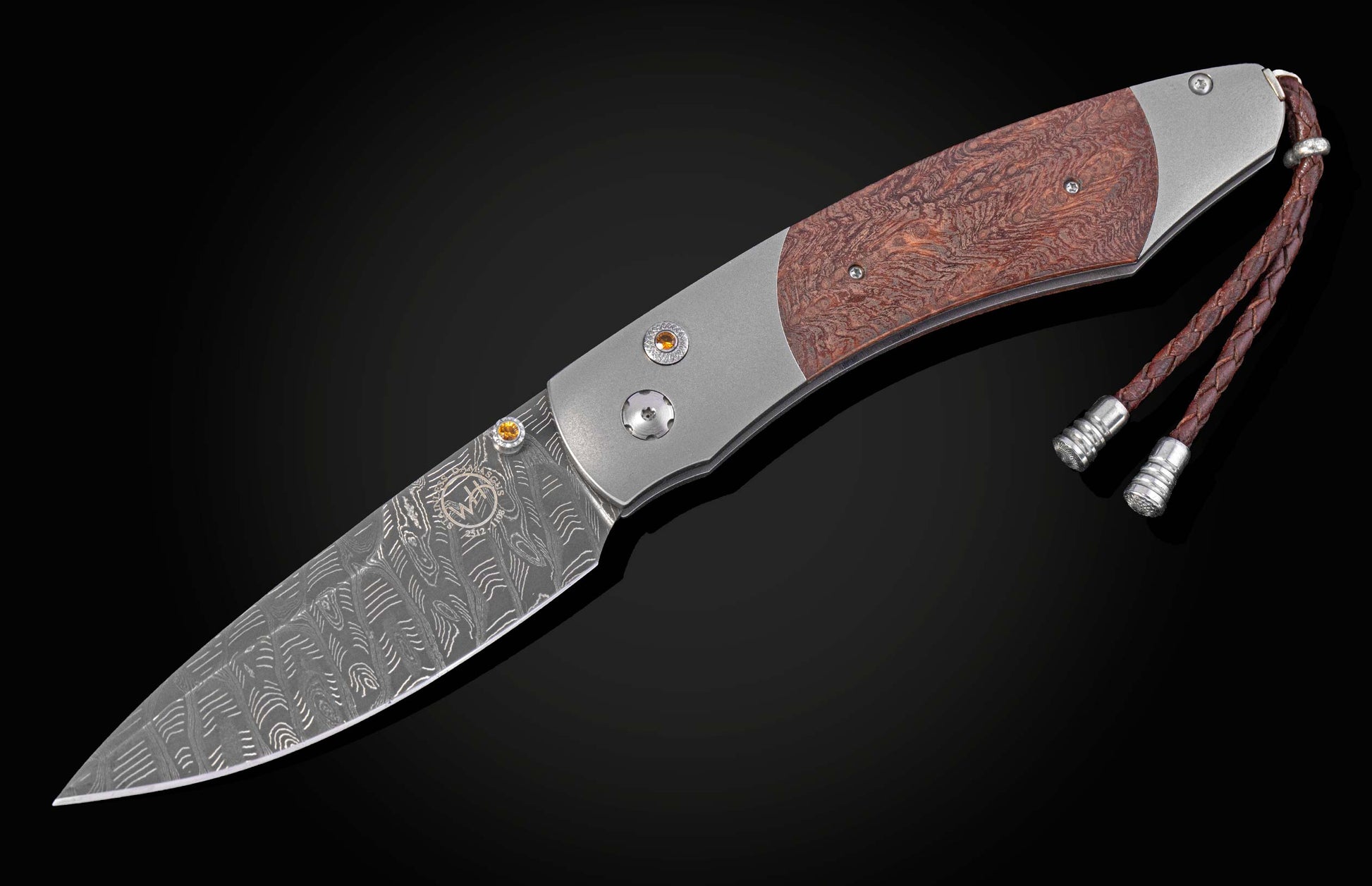 Folding knife with redwood handle and damascus blade open on a black background 