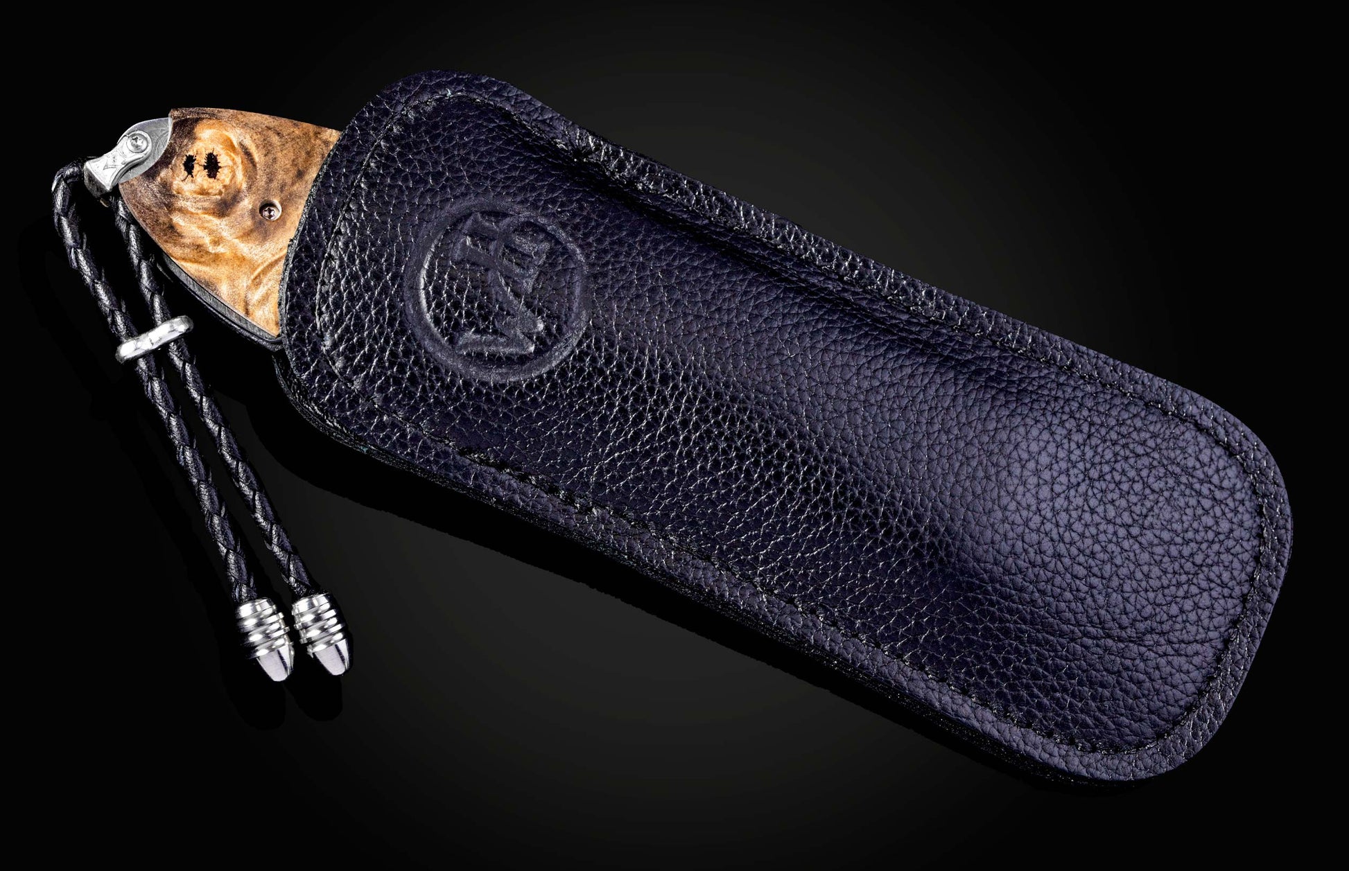 Decorative knife with artistic handle design on a black background