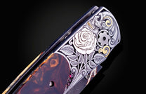 Decorative knife with artistic handle design on a black background