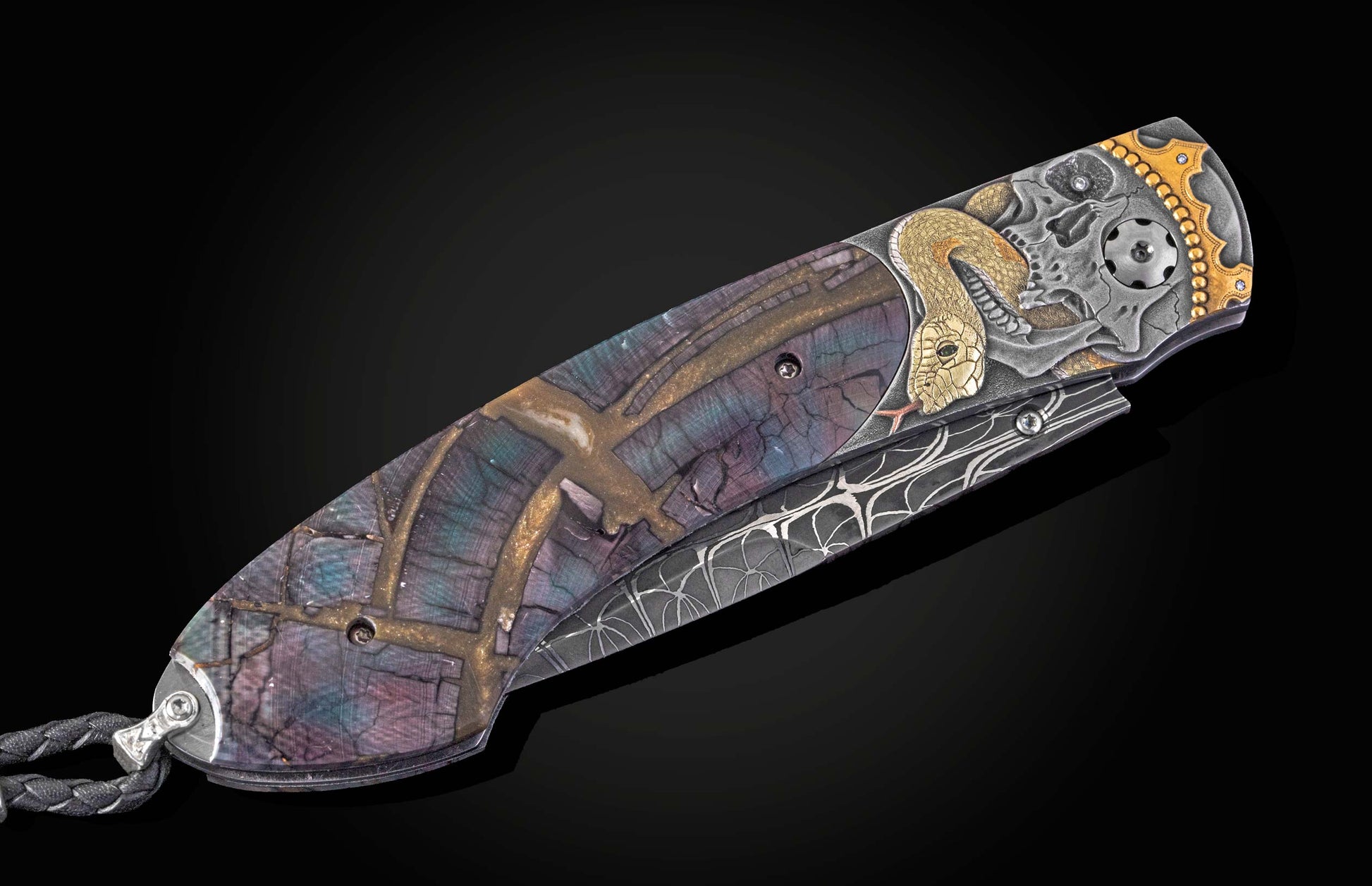Decorative pocket knife with intricate designs on a black background