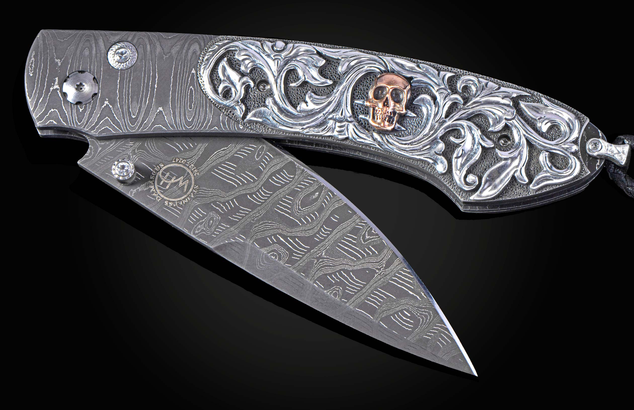 Hand carved silver folding knife with damascus steel on a black background