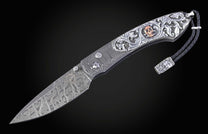 Hand carved silver folding knife with damascus steel on a black background