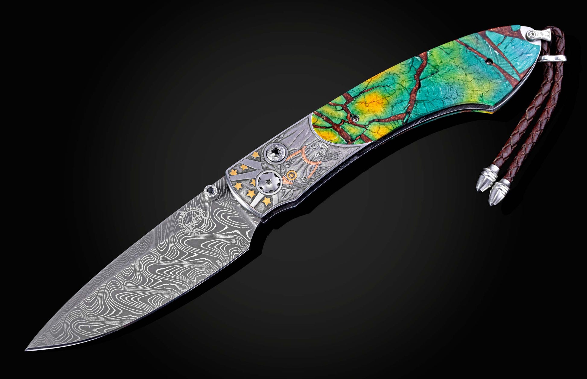 Folding knife with a wavy damascus steel blade, etched metal frame with gold stars, vibrant cracked handle, and braided leather lanyard.