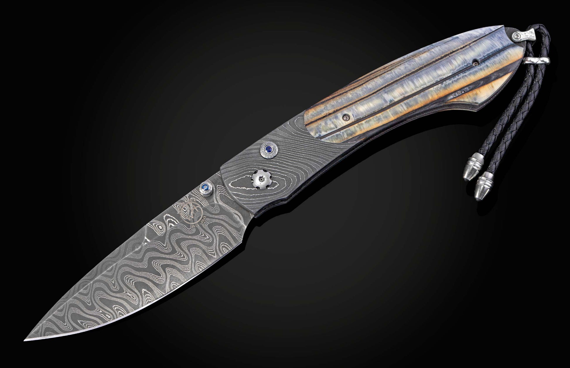 Folding knife with 10,000 year-old fossil Woolly Mammoth tooth and damascus blade on a black background shown open