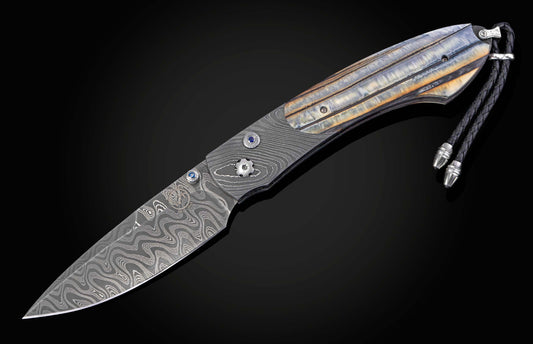 Folding knife with 10,000 year-old fossil Woolly Mammoth tooth and damascus blade on a black background shown open