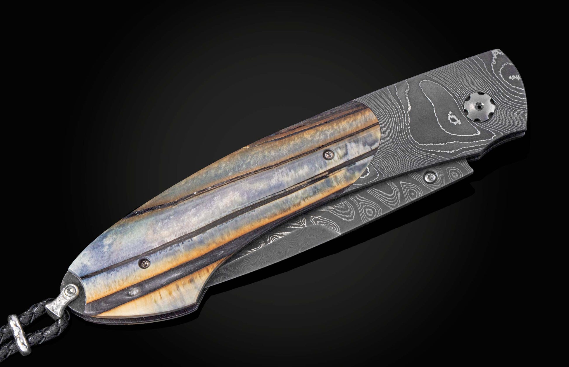 Folding knife with 10,000 year-old fossil Woolly Mammoth tooth and damascus blade on a black background shown closed