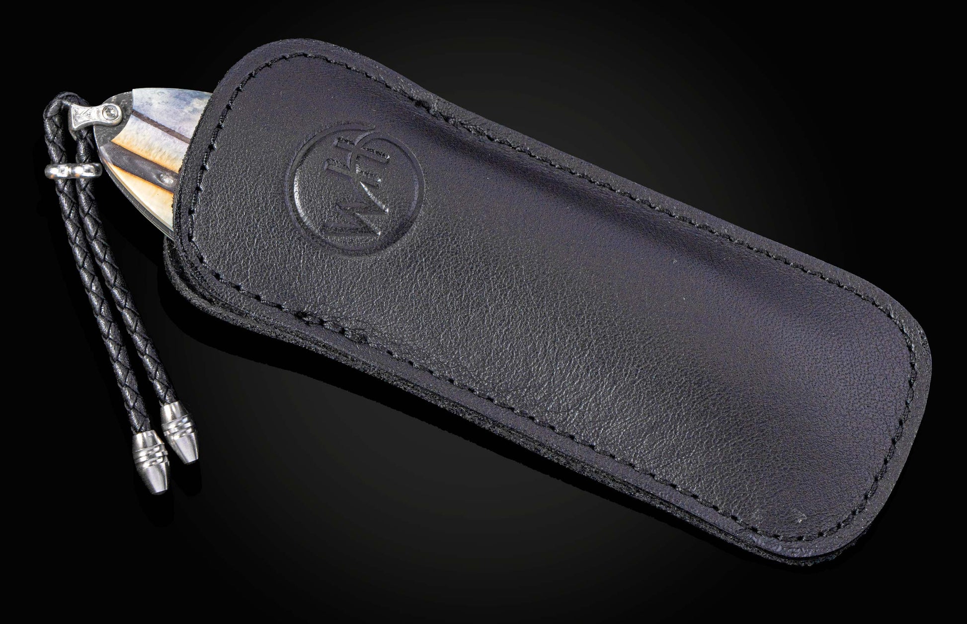 Black leather case with a knife on a black background