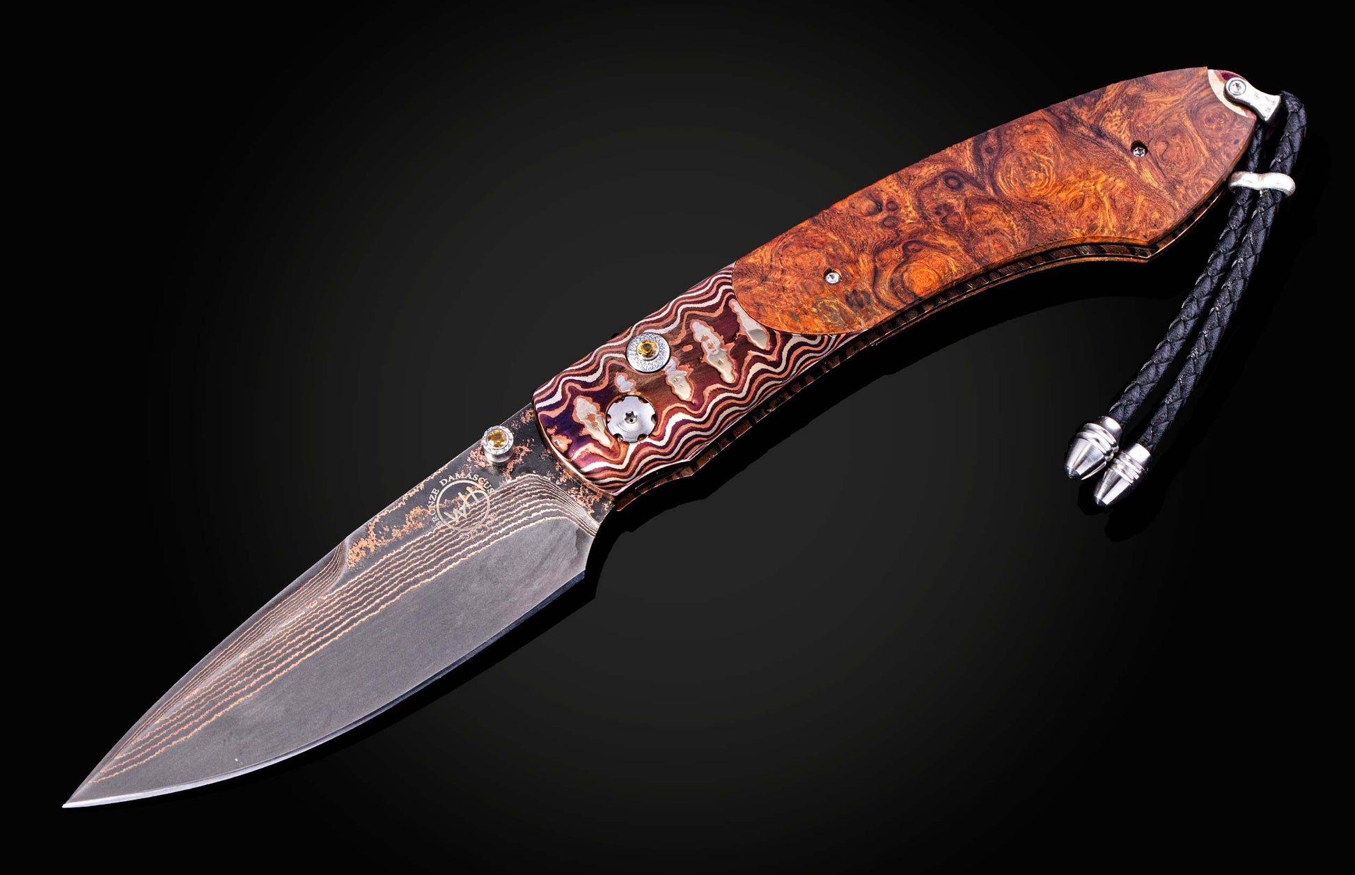 Folding knife with decorative wooden handle on a black background