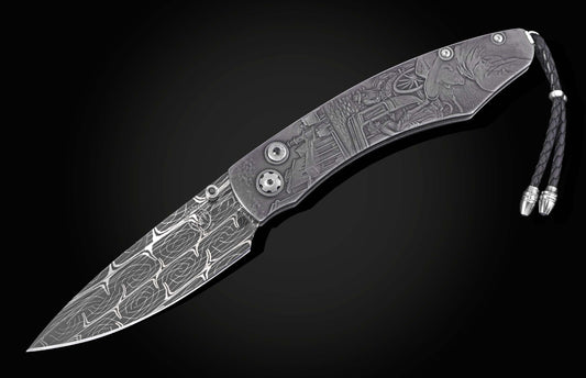 Ornate folding knife with a Damascus steel blade and engraved handle depicting a Western town scene, featuring a black leather lanyard.