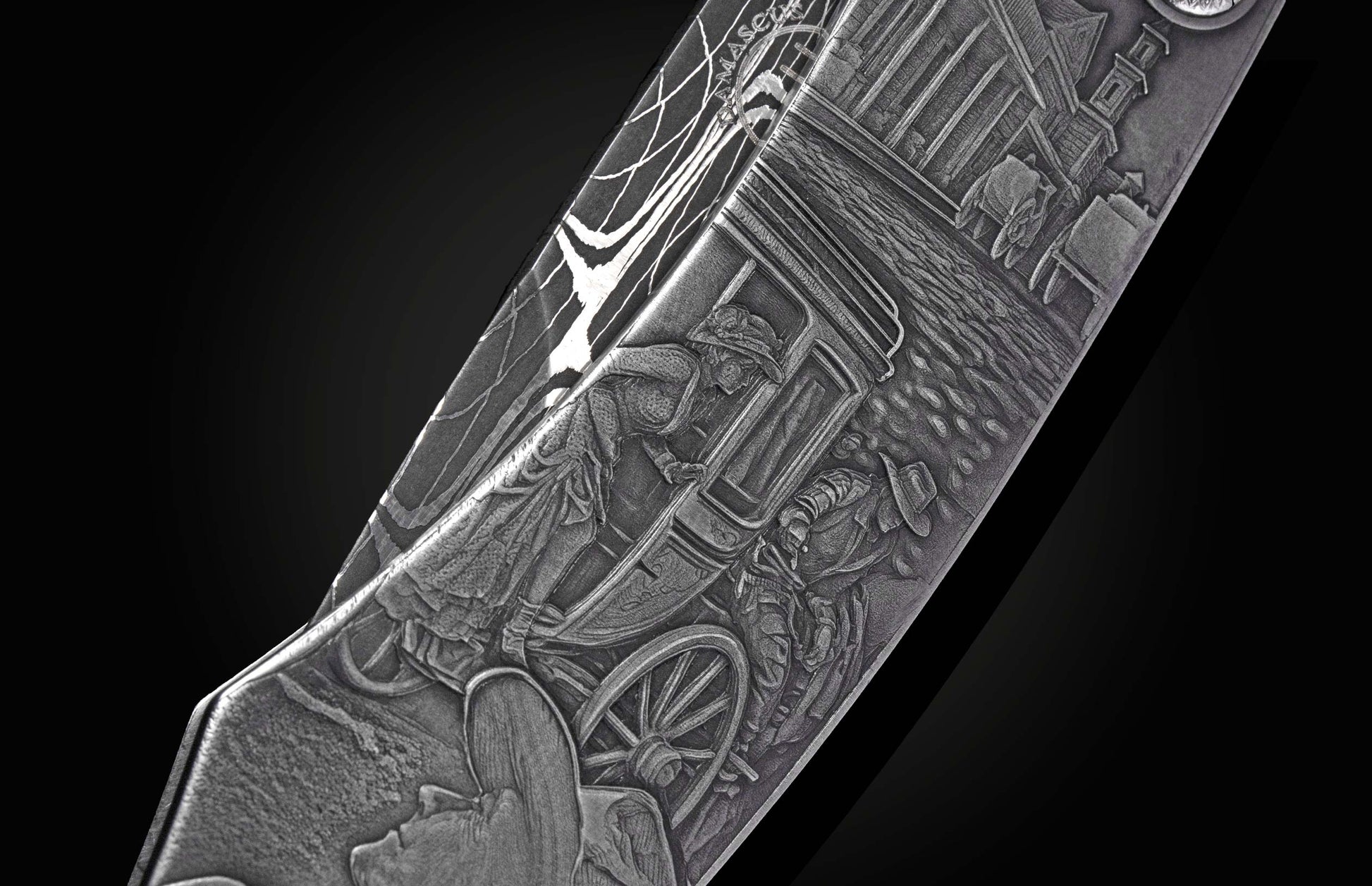 Knife with intricate Western-themed engraving of a stagecoach scene and a Damascus steel pattern on the blade.