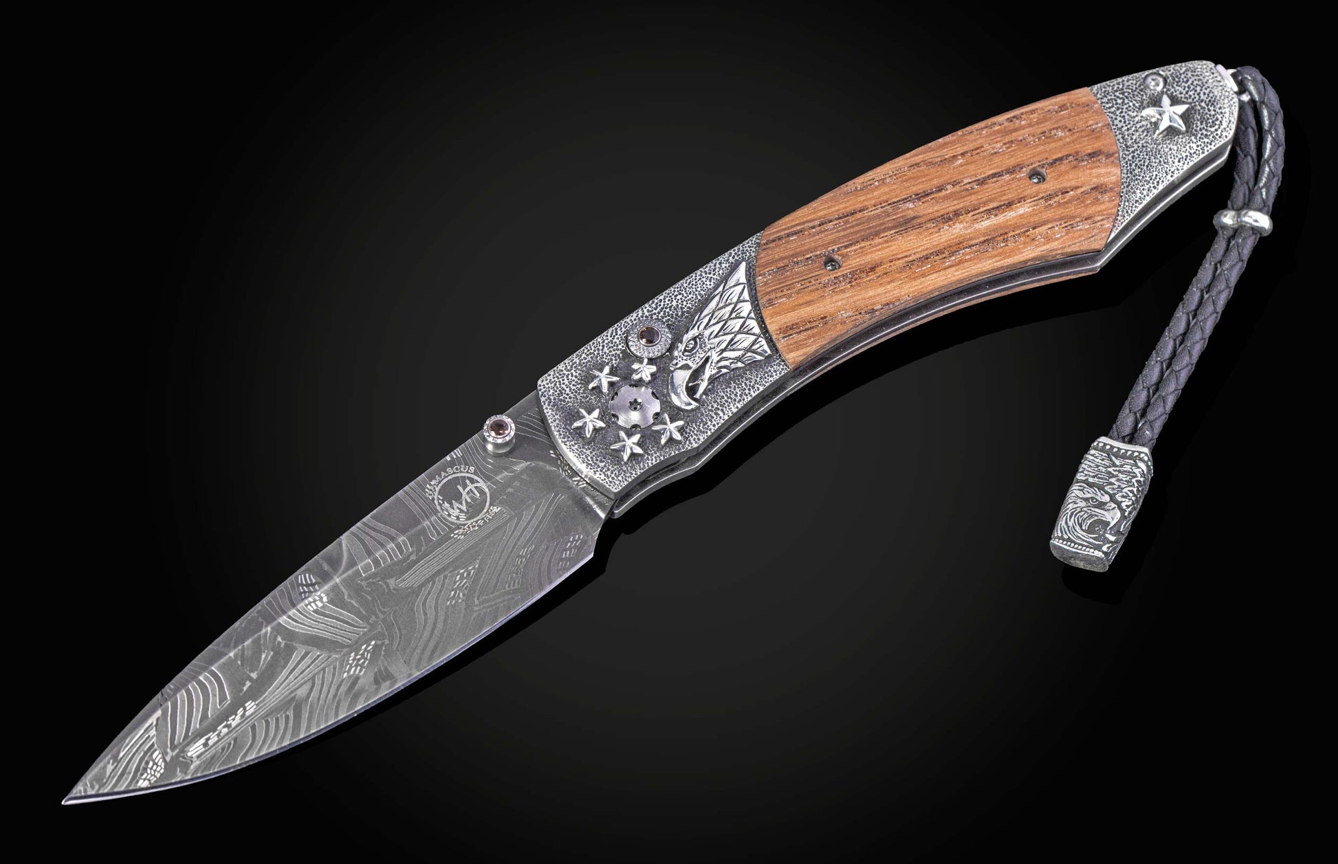 Folding knife with wooden handle and decorative blade on a black background