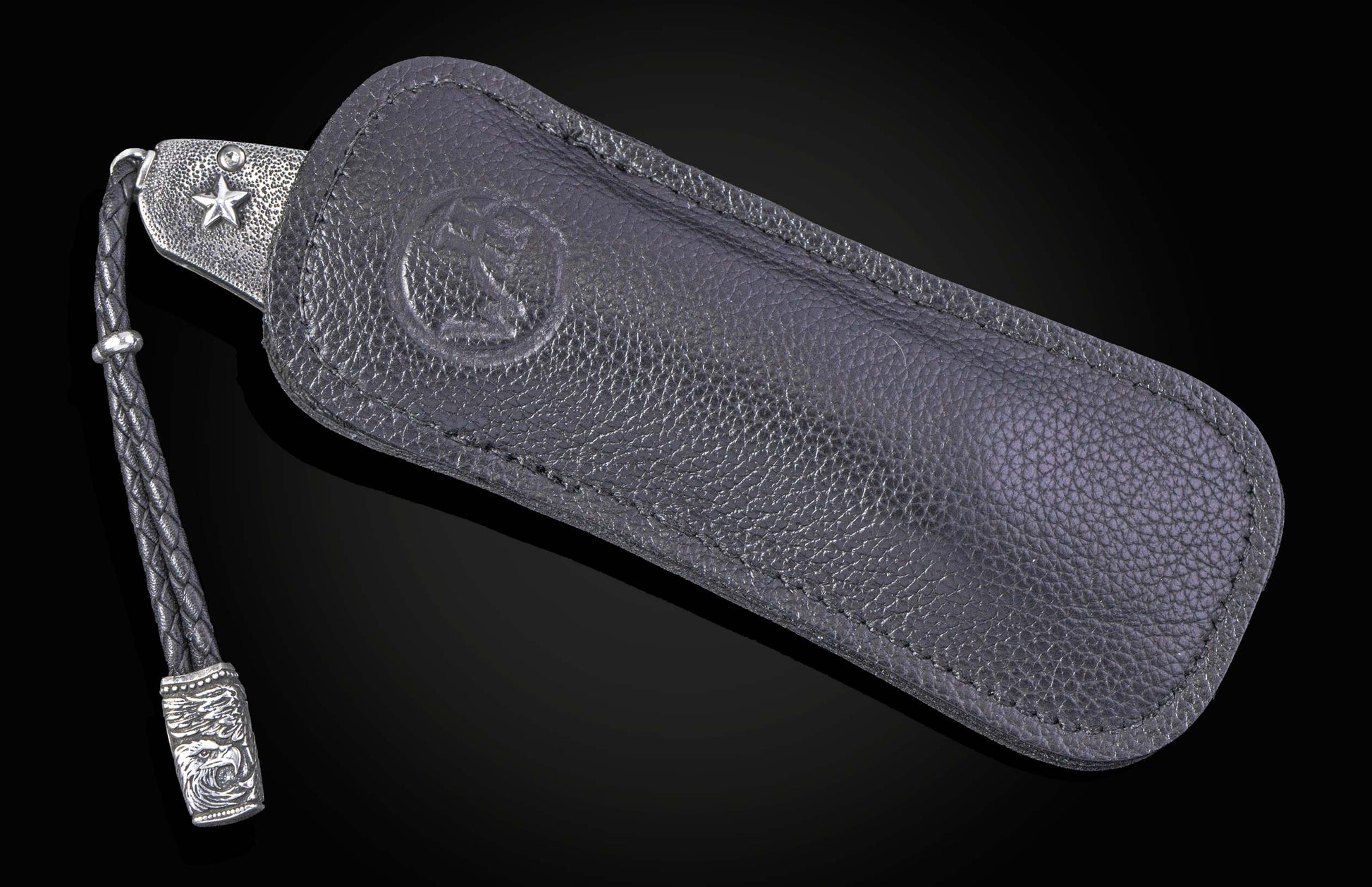 Folding knife with wooden handle and decorative blade on a black background