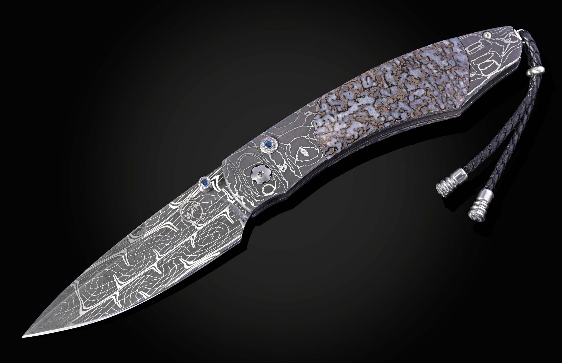 Decorative knife with damascus blade and dinosaur bone handle on a black background shown fully open
