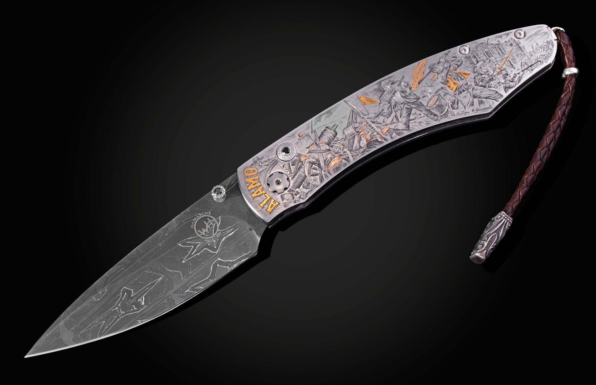 Decorative folding knife engraved with images from the Alamo on a black background