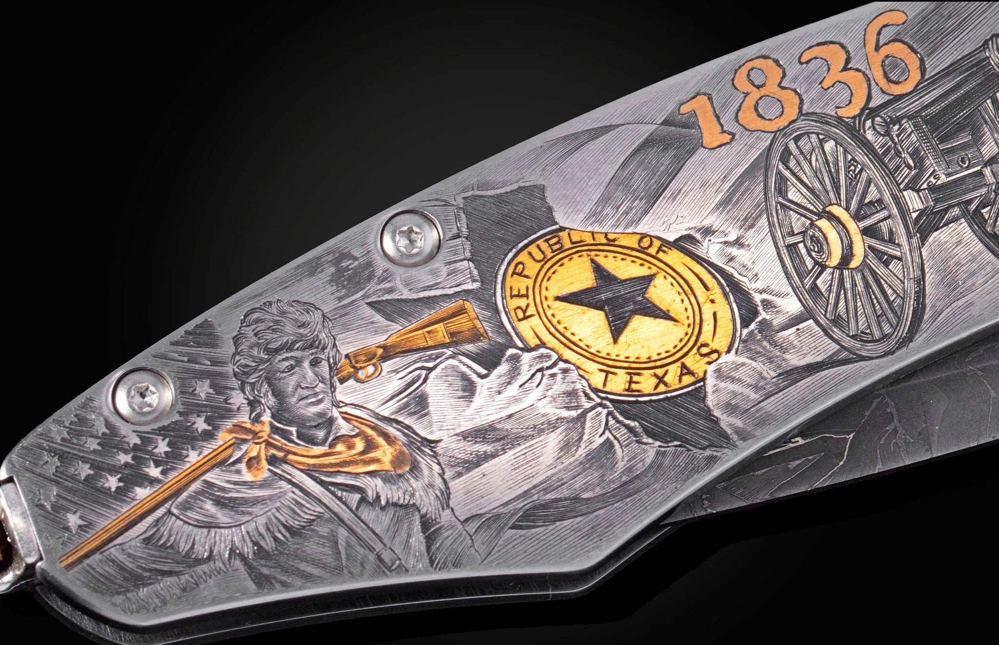 Decorative folding knife engraved with images from the Alamo on a black background