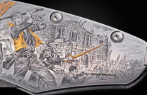 Decorative folding knife engraved with images from the Alamo on a black background