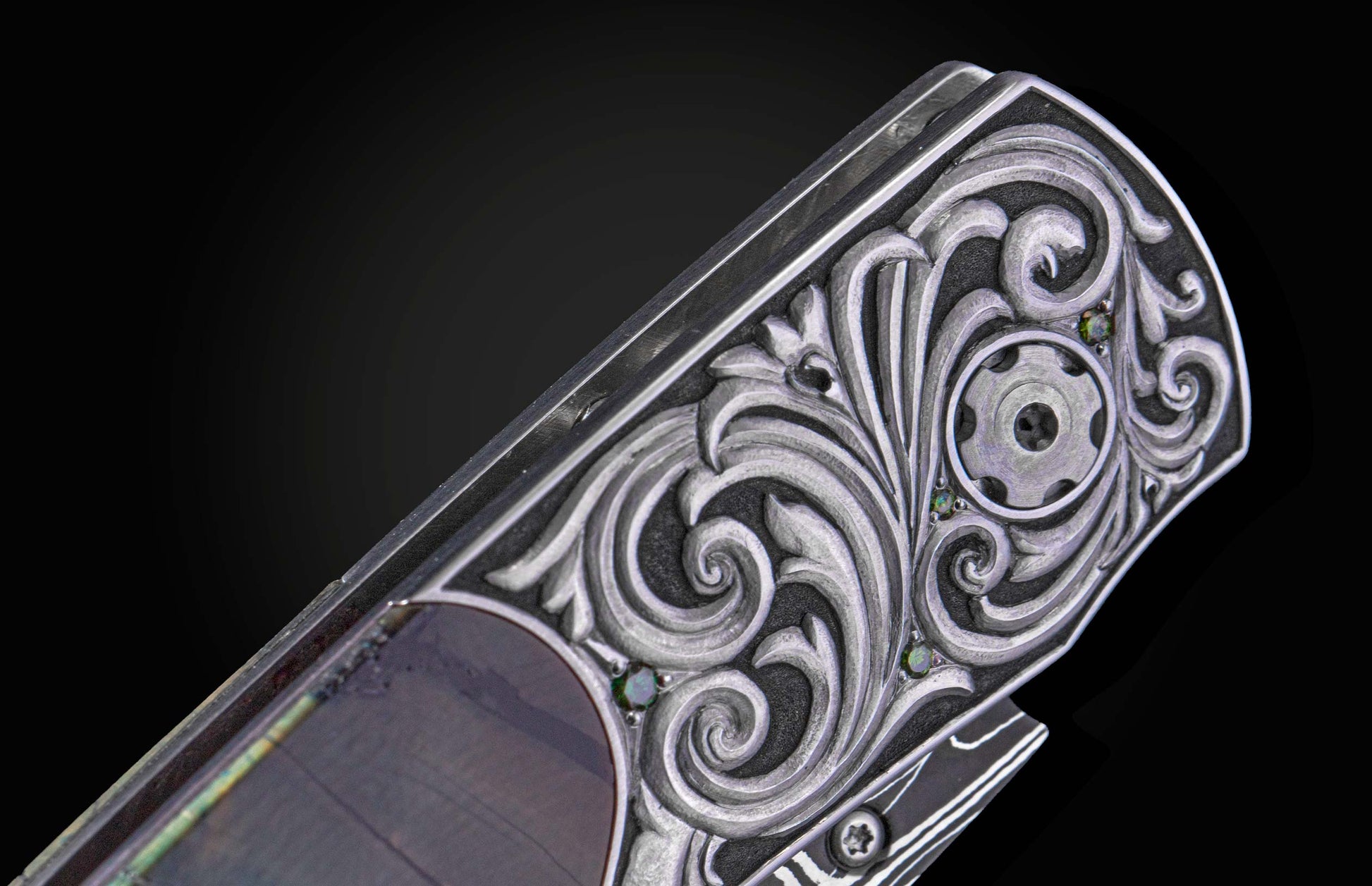 Decorative knife with damascus blade and fossilized woolly mammoth tusk scales on a black background