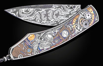 Folding knife with a wavy Damascus steel blade and an elaborately engraved handle depicting a watchmaker, clocks, tools, and skulls, with iridescent accents.