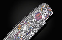 Engraved metal knife with intricate skull, clock, and gear design in vibrant colors, featuring a Damascus pattern.