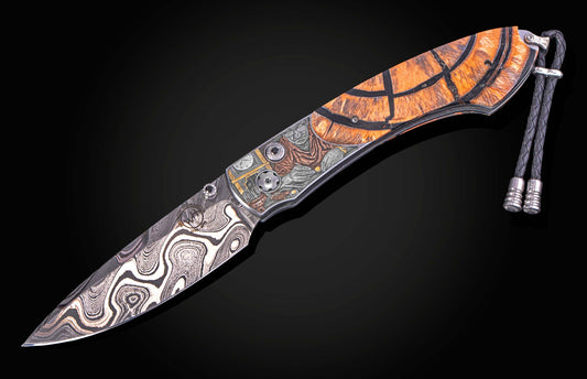 William Henry knife with woolly mammoth tusk, hand engraving, and damascus steel blade.