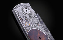 Folding knife with Damascus steel blade , hand engraving, and desert ironwood handle on a black background