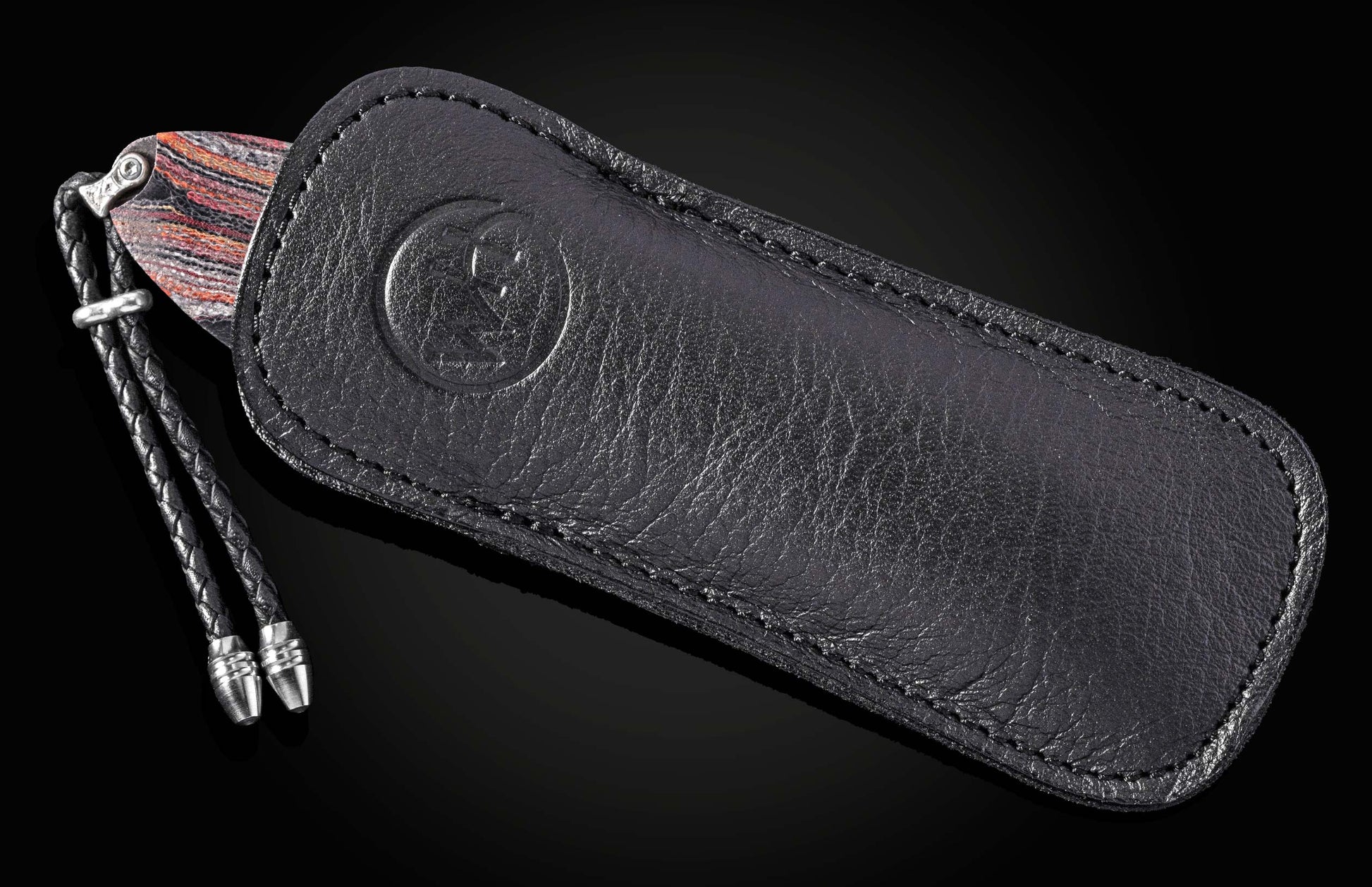 Luxury black leather knife sheath with embossed logo, braided cord and metallic tips, side view