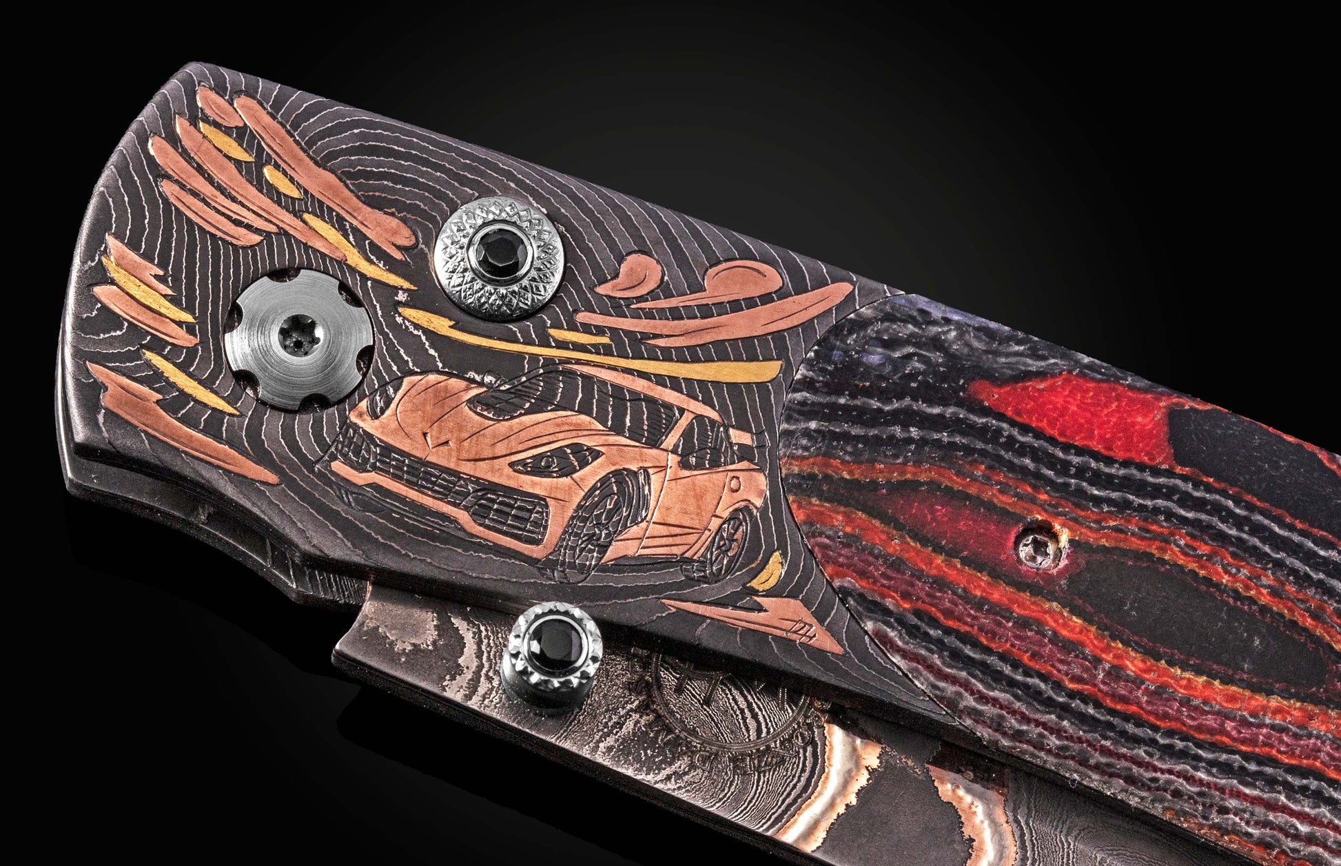 Luxury folding knife with damascus steel blade and copper car inlay, by B12 ZR1, featuring textured black handle with red accents and decorative screws, side view