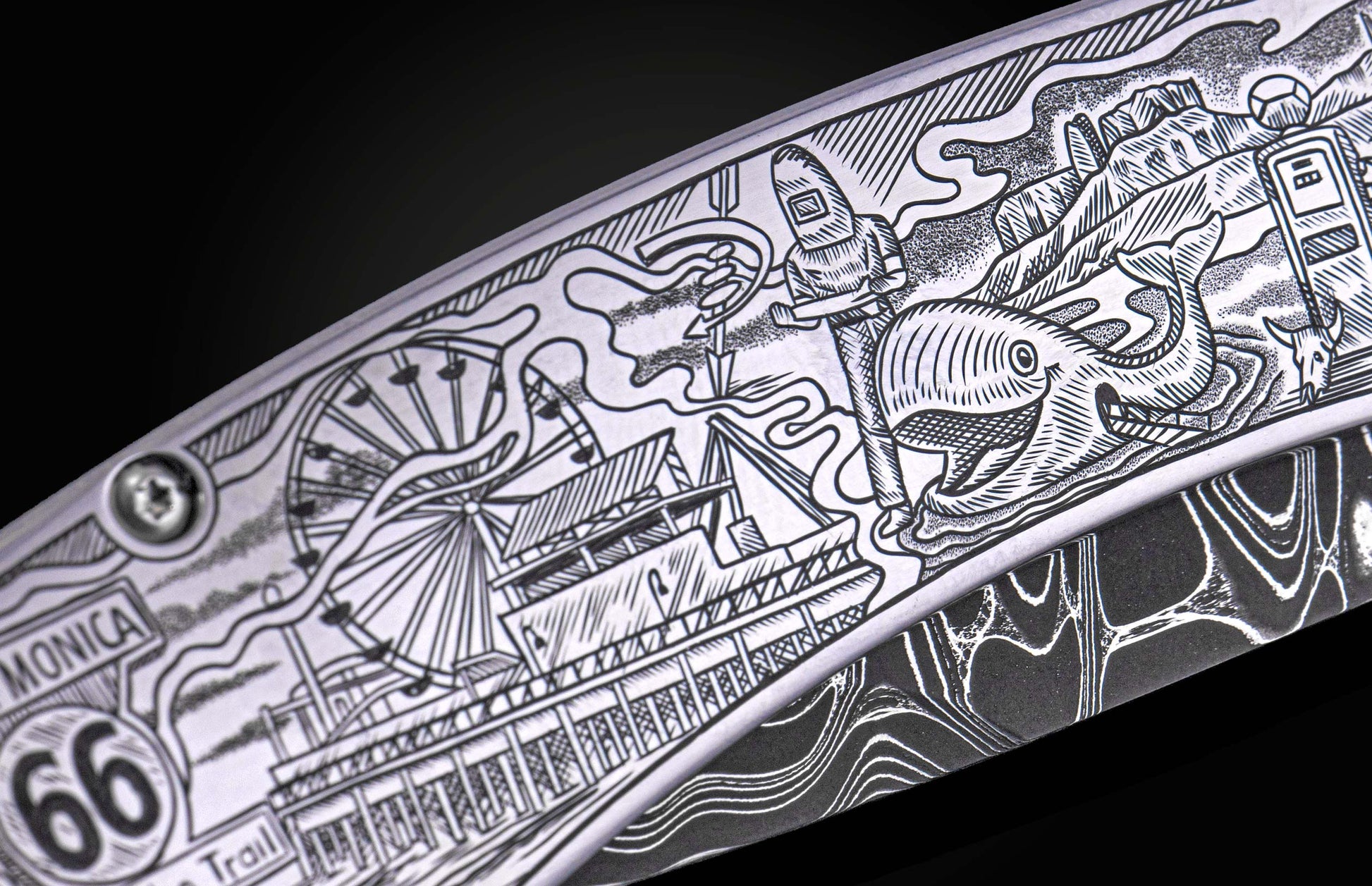 Silver-toned engraved metal knife blade featuring a Route 66 theme with 'Monica', '66', and an amusement pier.