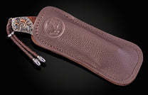 William Henry knife with hand-carved sterling silver, mokume gane, desert ironwood, and damascus steel blade