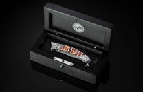 Black open box with a knife inside on a black background