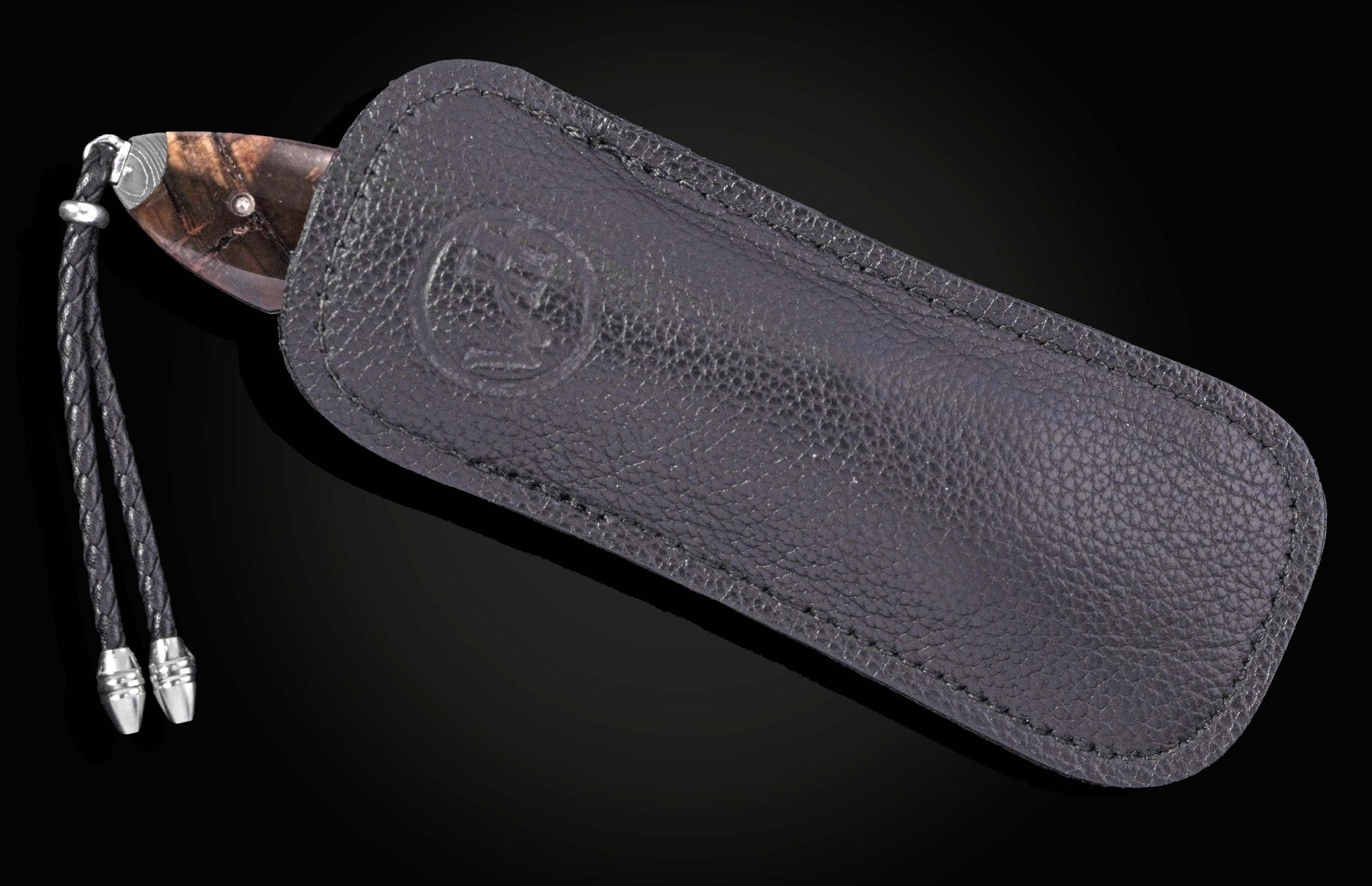 custom folding knife in a black leather sheathe