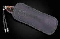 custom folding knife in a black leather sheathe