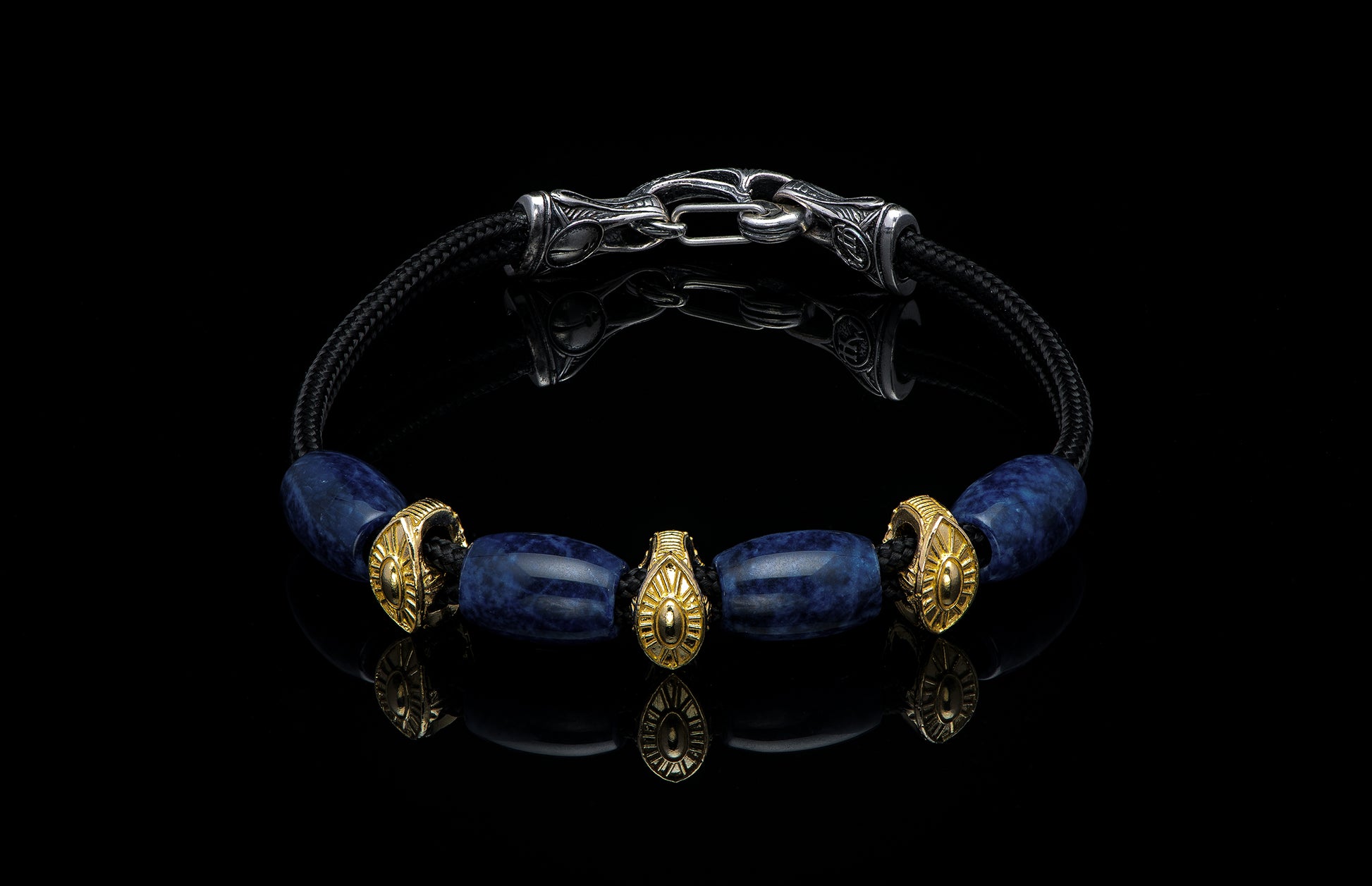 Bracelet featuring sodalite and gold beads with silver clasp