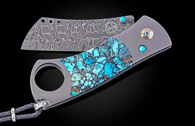 Luxury damascus steel cigar cutter with turquoise inlay and brushed titanium handle, by Kingman, featuring beaded lanyard and polished gemstone accents.