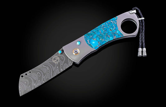 William Henry cigar cutter with turquoise handle and damascus blade on a dark background