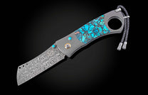 Luxury damascus steel cigar cutter with turquoise inlay and braided cord, by CG1 Kingman, side view on black background