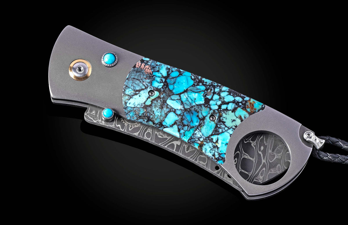 Turquoise inlay cigar cutter with damascus steel accents and gemstone details, side view on black background