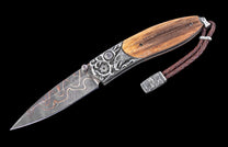 Decorative folding knife with wooden handle and damascus steel blade on a black background