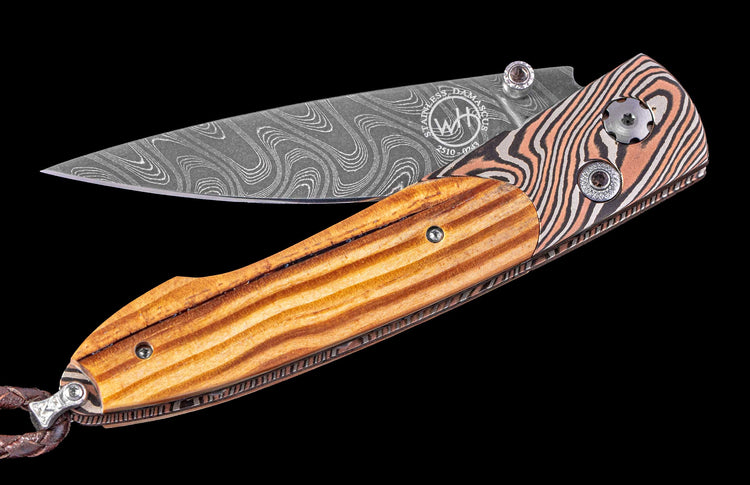Pocket knife with wooden handle and damascus blade on a black background