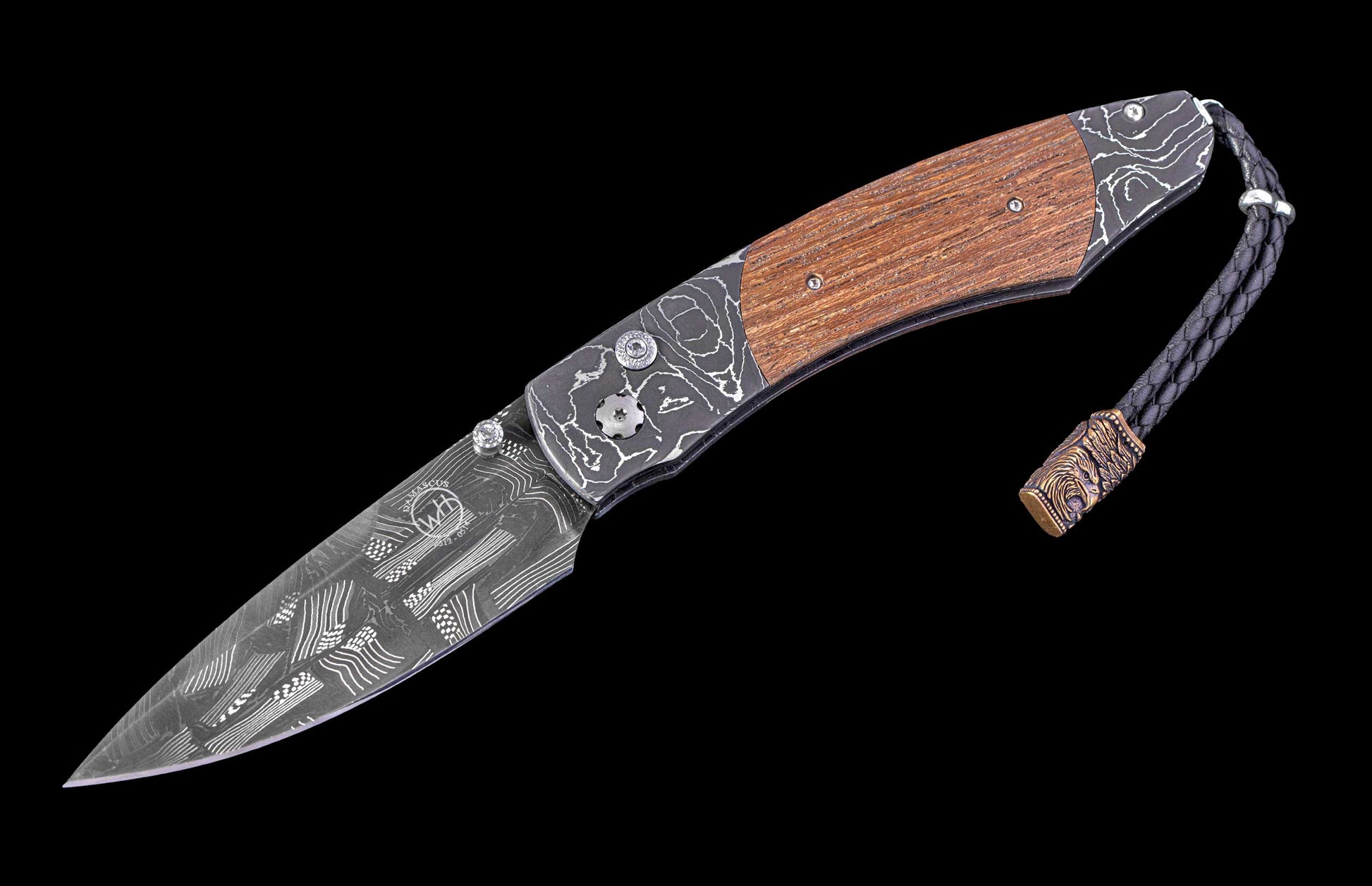 Foldable knife with wooden handle and engraved blade on a black background