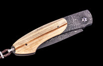 Folding knife with wooden handle and damascus steel blade on a black background
