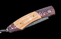 Folding knife with a decorative wooden handle and metal blade on a black background