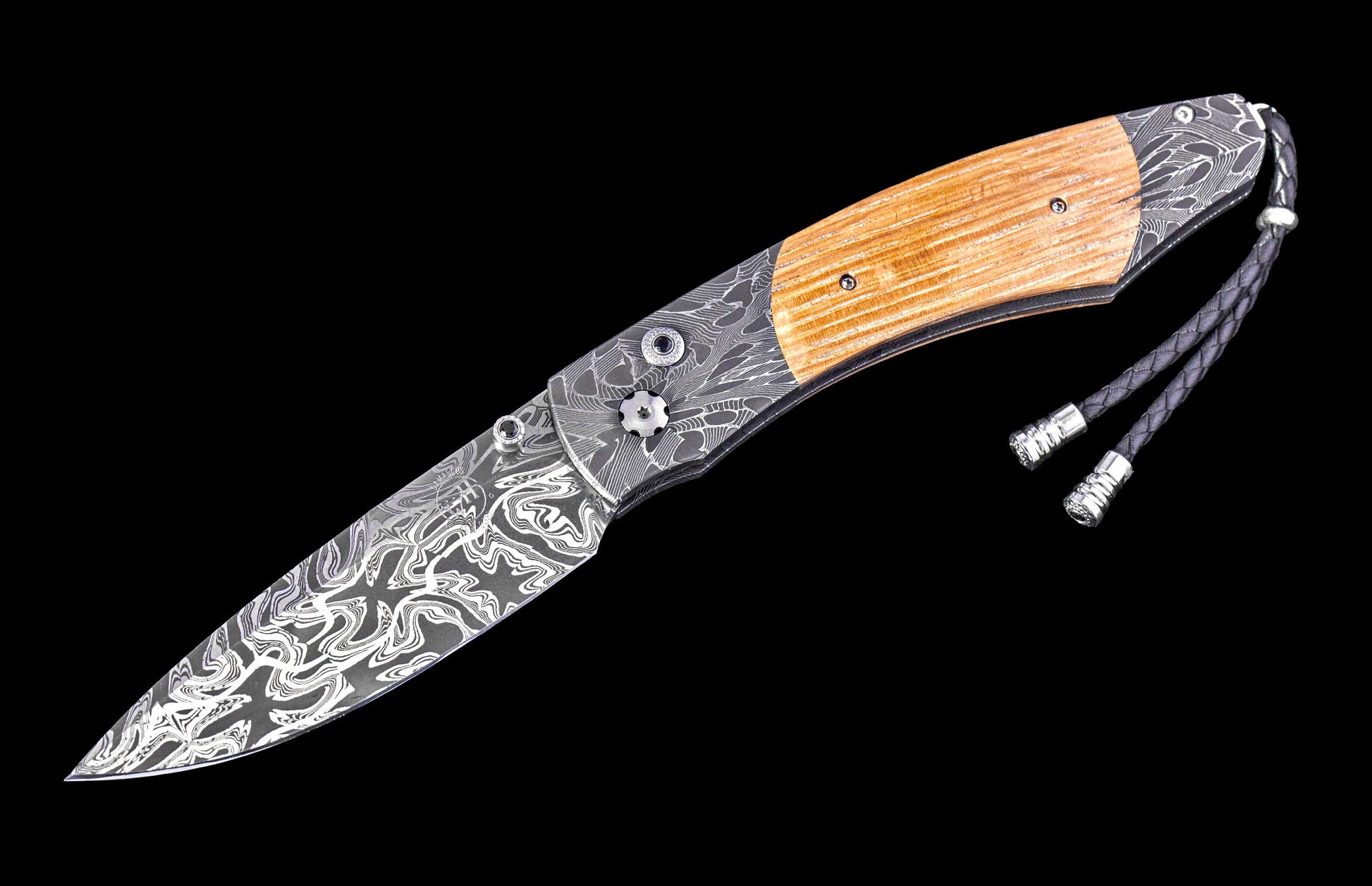 Folding knife with wooden handle and decorative blade on a black background