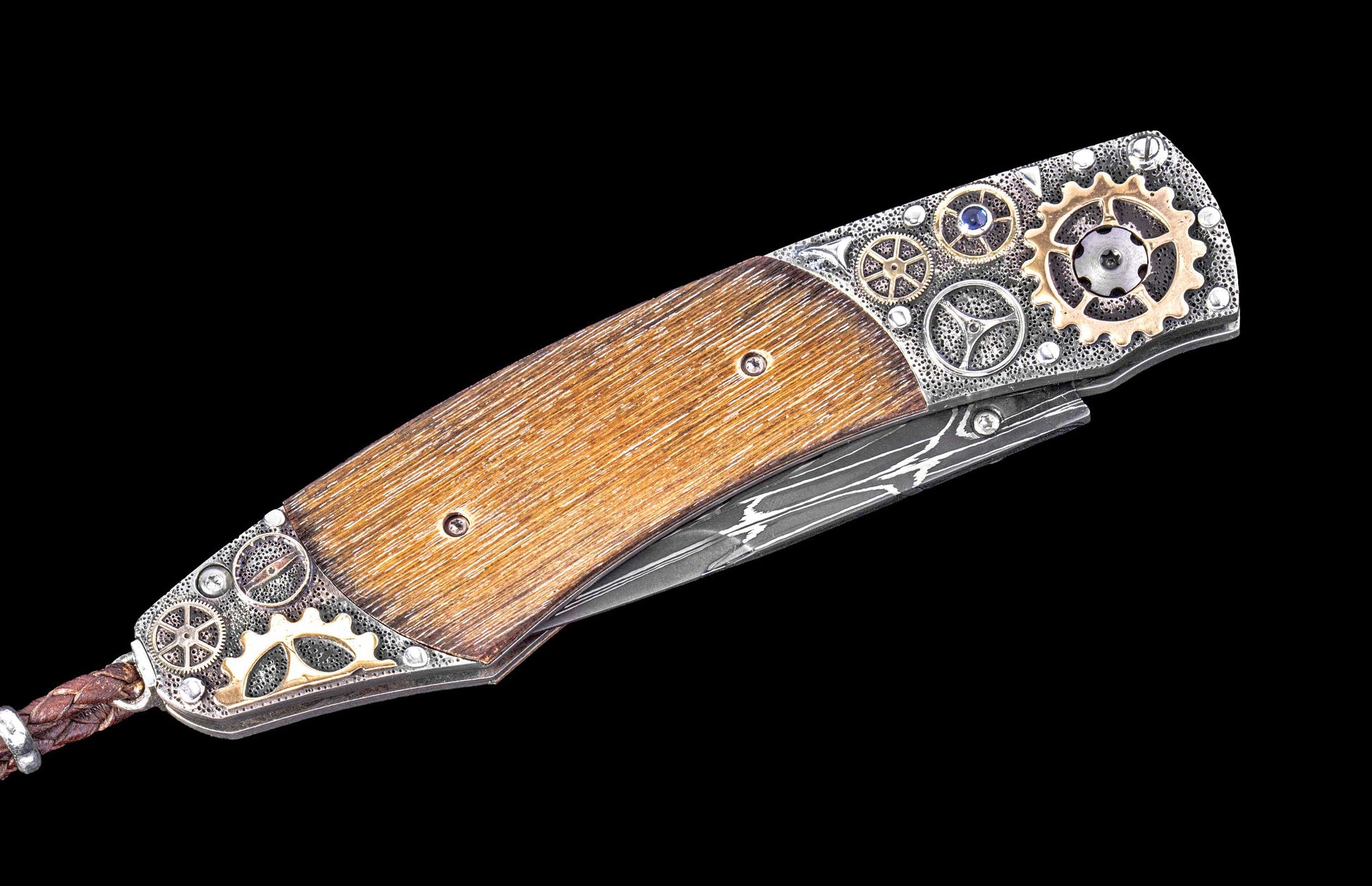 Decorative folding knife with wooden handle and metal embellishments on a black background