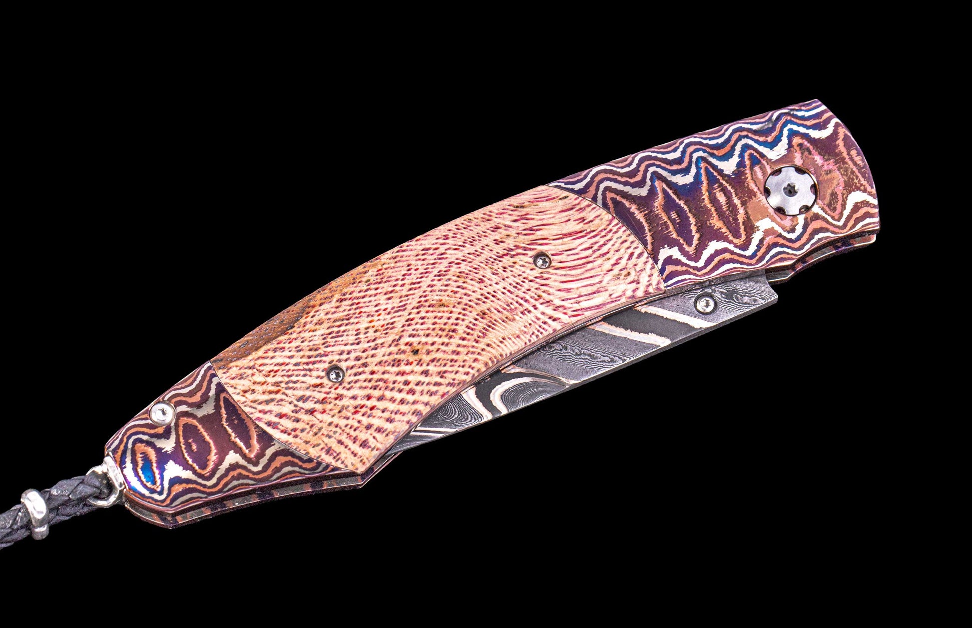 Decorative knife with a patterned blade and handle on a black background