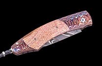 Decorative knife with a patterned blade and handle on a black background