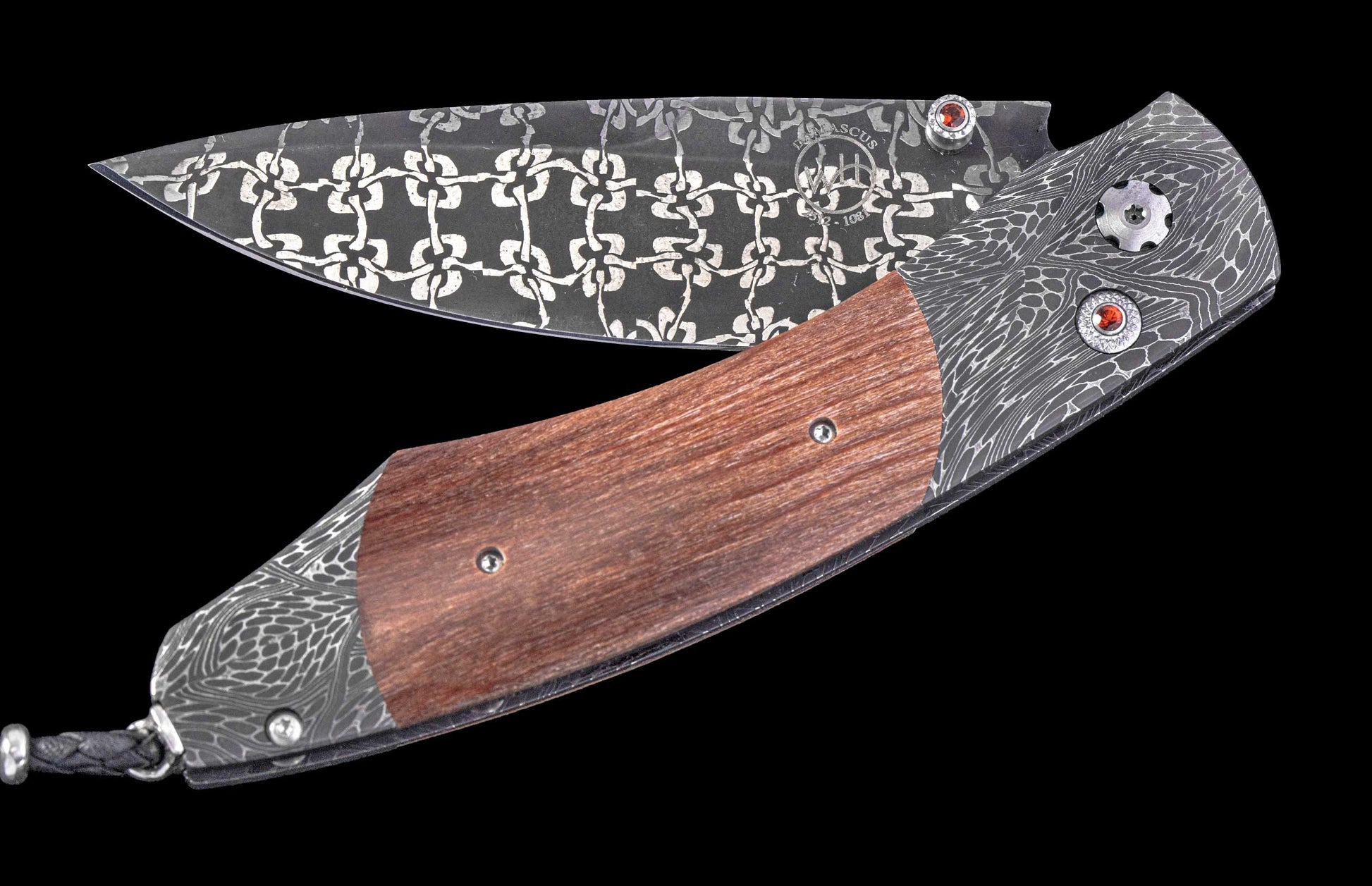 Open folding knife with an ornate Damascus steel blade and handle, featuring a rich brown wood inlay and decorative red gems.